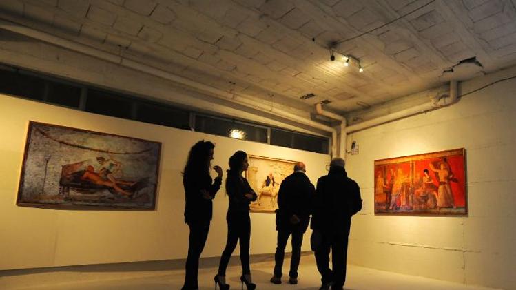 Visitors look at artworks at the opening of the ErotiCAM_Secret Room II exhibition, censored by the Italian culture ministry at the Casoria Contemporary Art Museum near Naples on November 28, 2013